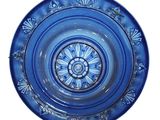 a blue glass plate with a circular design on it