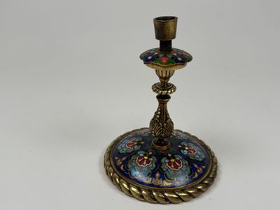 a close up of a candle holder on a white surface