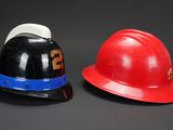 two hats that are sitting next to each other on a table