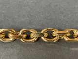 an image of a close up of a gold chain on a table