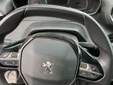 the interior of a car with a steering wheel and dashboard controls