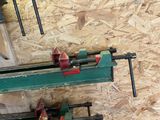 a clamp on a bench with a couple of tools