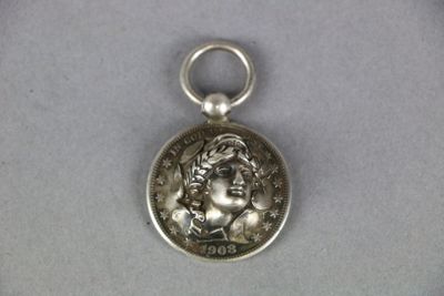 a close up of a silver coin with a woman on it