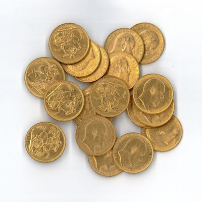 a pile of gold coins sitting on a white surface