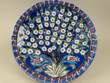an image of a decorative plate with a tree of flowers on it