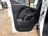 the door of a white truck with the driver ' s seat open