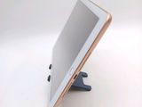 a tablet that is sitting on a stand on a table