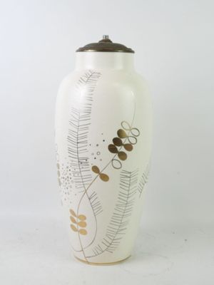 a white vase with a black lid sitting on a white surface