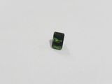 a green tourmaline stone on a white surface