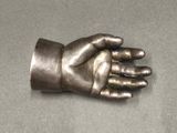 a metal hand that is sitting on a table