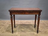 an old wooden table sitting on top of a hard wood floor