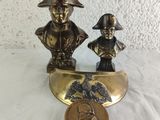 a bronze statue of a man and a boy on a boat
