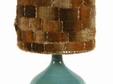 a blue vase with a woven shade on top of it