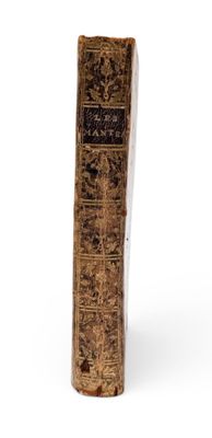 an old book sitting on top of a table next to a white background