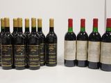 several bottles of wine are lined up on a white surface