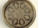a silver tray with a decorative design on it