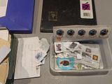 a box of mail and a box of stamps on a table