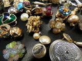 many different types of jewelry on a black surface