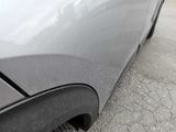 a close up of a car ' s exhaust pipe on the side of the road