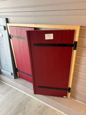 two red and one grey doors are next to each other in a room