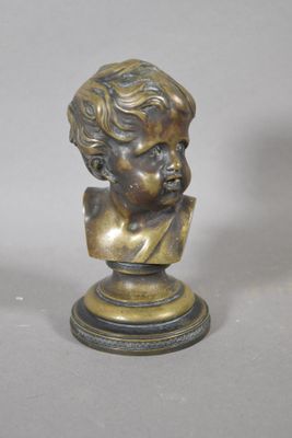 bronze bust of a young boy with curly hair on a pedestal