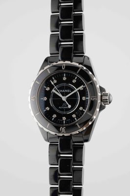 the watch is black and silver with a black face