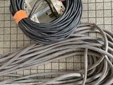a cable and a plug laying on the floor next to each other