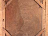 a close up of a wooden frame with a square design on it