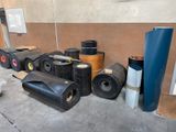 many rolls of black plastic on the ground next to each other