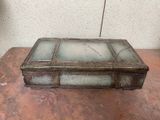 a glass box sitting on a table on the floor
