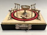 a silver plate with a red ring on top of it