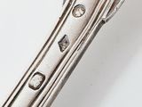 a close up of a silver spoon on a white surface