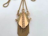 a gold plated necklace with a long chain hanging from it