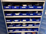 a blue cabinet with many blue bins in it
