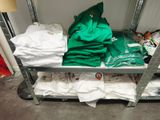 a metal shelf with a bunch of shirts on top of it