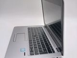 a silver laptop with a blue sticker on the screen
