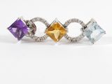 an image of three rings with different colored stones on a white background