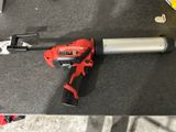 an electric tool sitting on top of a table next to other tools