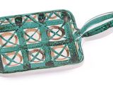 green and white square shaped dish with handles on a white surface