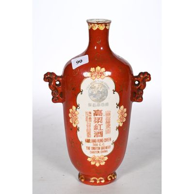 a red vase with a picture of a man on it
