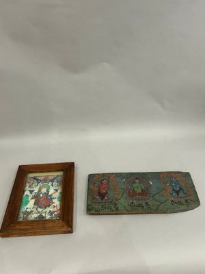 two pieces of art on the table next to each other