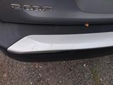 a close up of a car ' s rear bumper with a sticker on it
