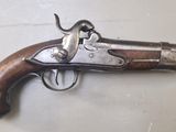 gros plan d'un pistolet sur une table à fond blanc