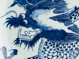 a blue and white plate with a dragon on it