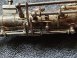 a silver saxophone that is sitting on a table