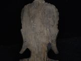 a wooden statue of an elephant on a black background