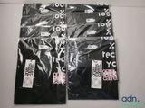 four bags of black and white condoms are on a white surface