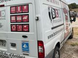 a van that is parked in a lot with stickers on it