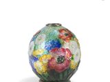 a vase with flowers painted on it on a white surface