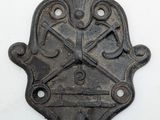 an old iron clock on the wall with a cross on it